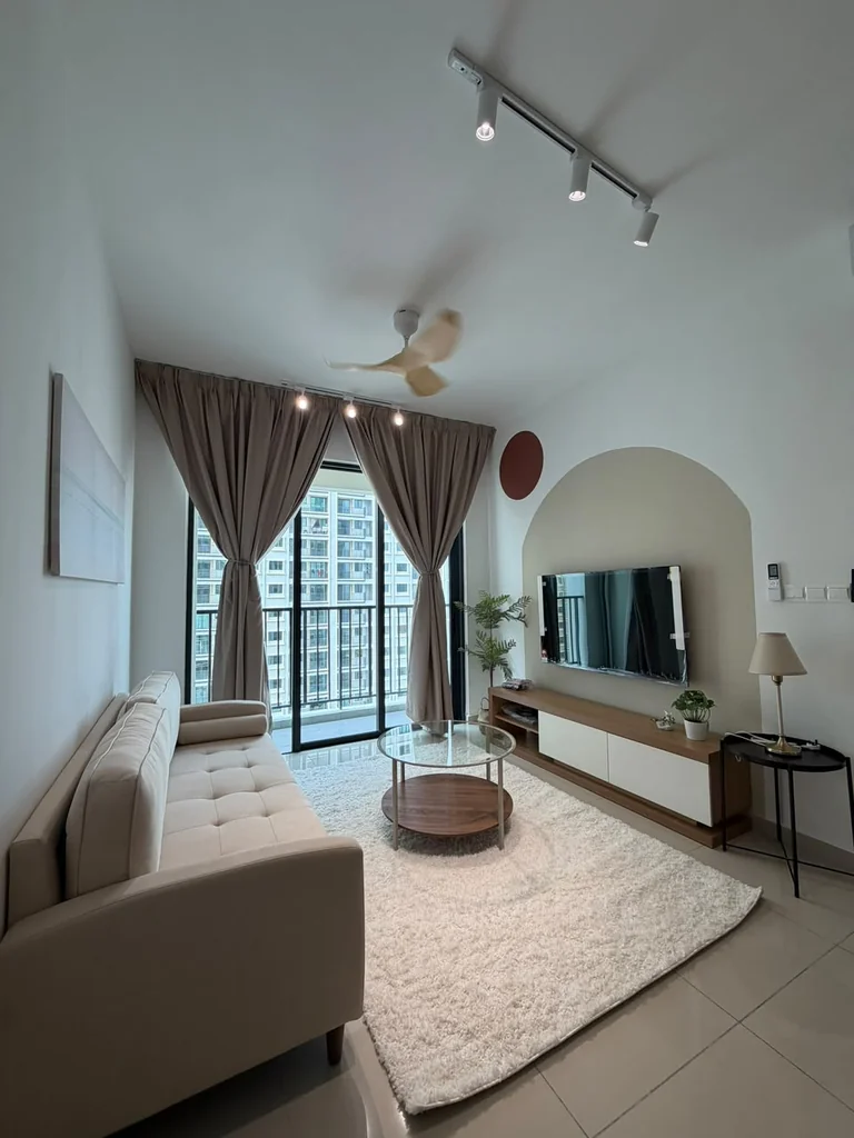 Furnished living room at Ideal Venice with sofa, television and balcony curtains